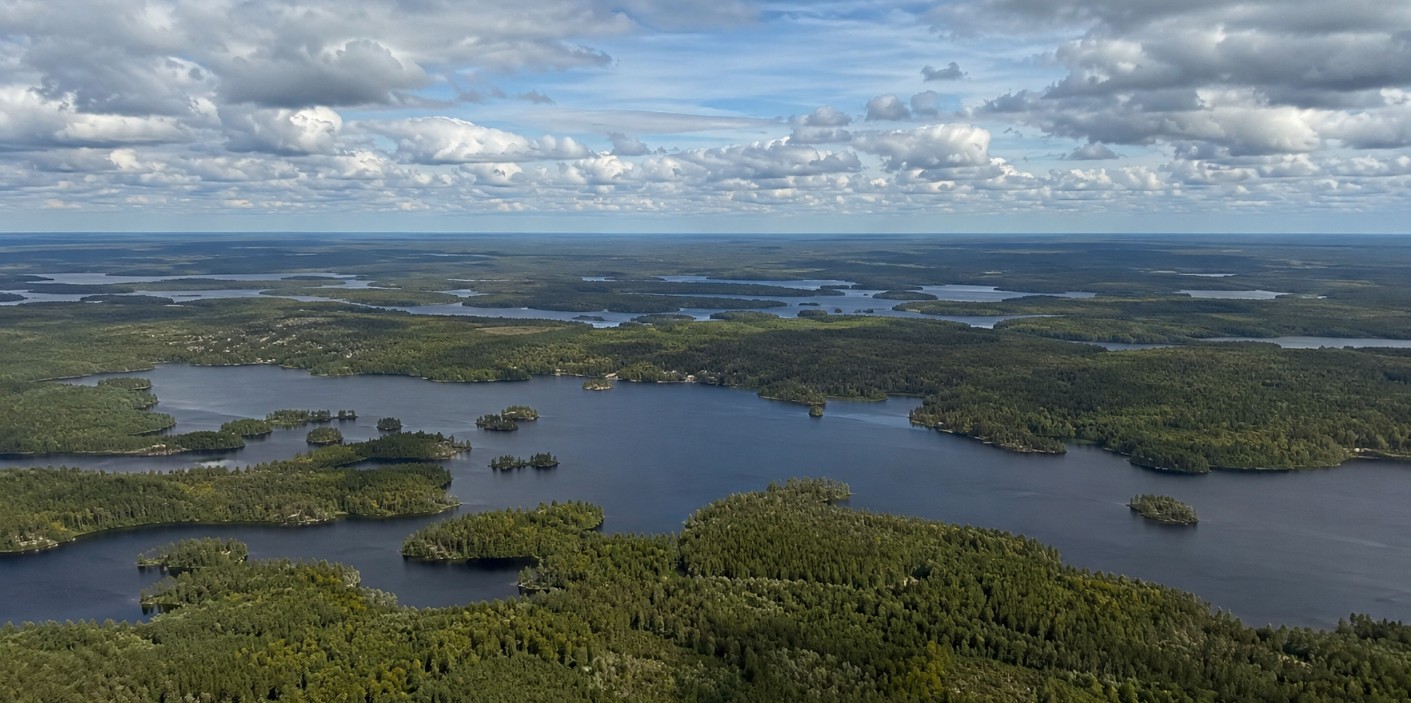 Wide Northern Ontario landscape of lakes and forest stretching to the horizon